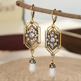 Vintage goldene Ohrringe mit eingelegter Perle
