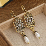 Vintage goldene Ohrringe mit eingelegter Perle